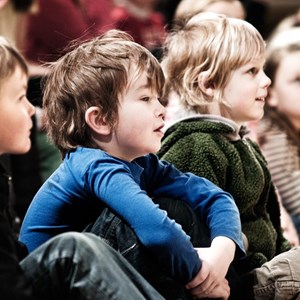 Skolbarn tittar uppmärksamt på teater föreställning